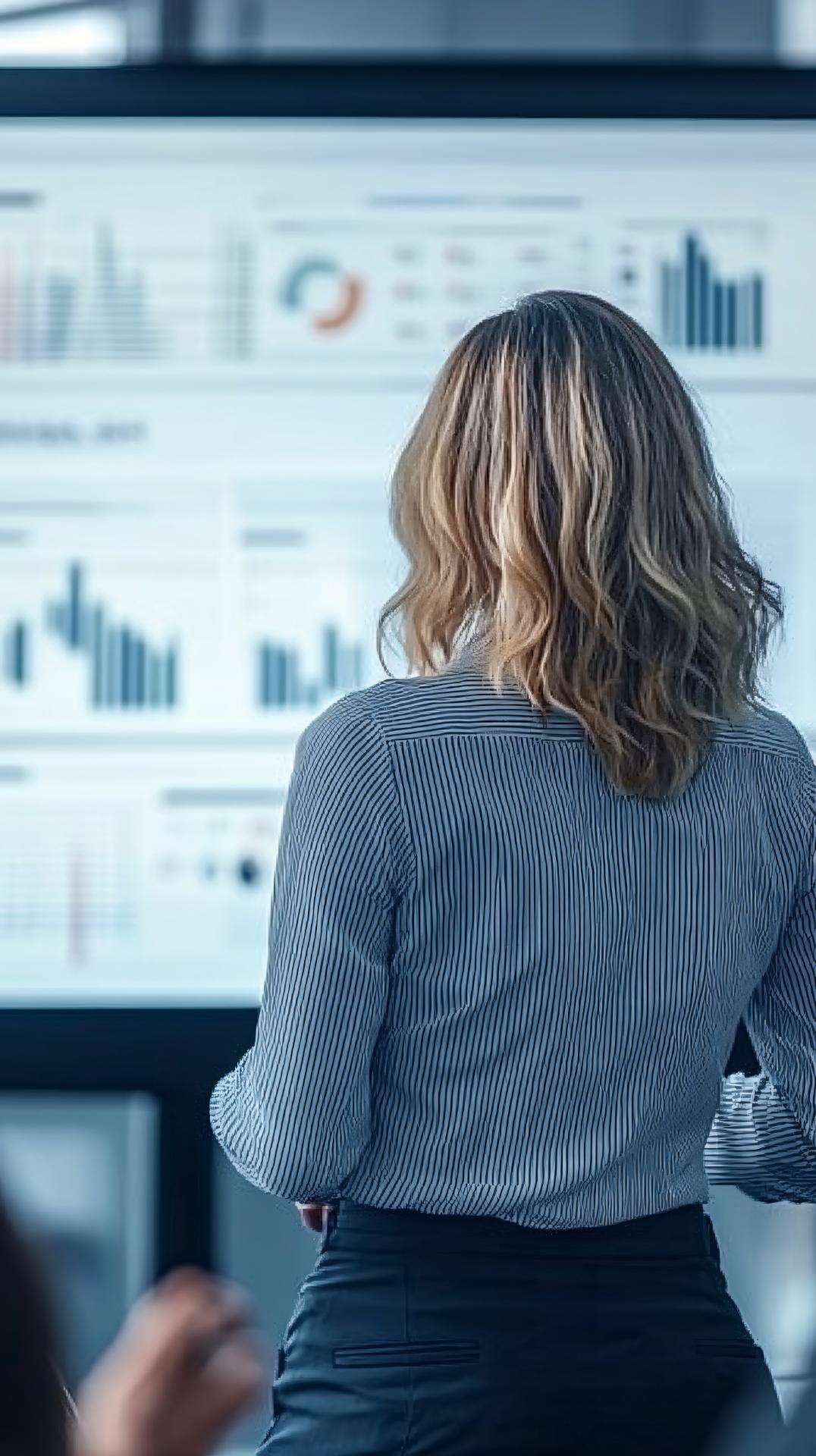 Female Bank Manager Giving Presentation Her Team Bright Meeting Room With Large Screen Displaying Graphs